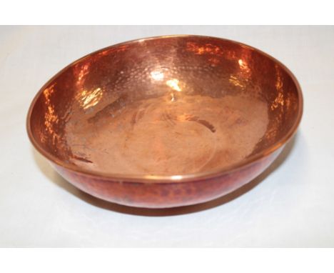 A Newlyn copper circular bowl with beaten decoration stamped "Newlyn" 8" diameter