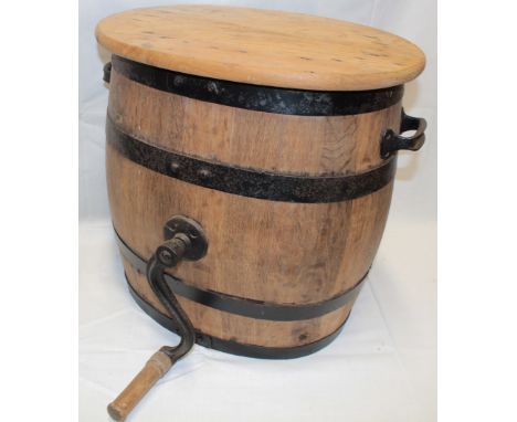 An old metal-bound oval two handled portable butter churn with hand cranked handle and oval lid 20" high