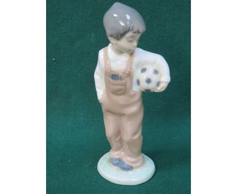 NAO GLAZED CERAMIC FIGURE OF A BOY WITH BALL, APPROXIMATELY 20cm HIGH 