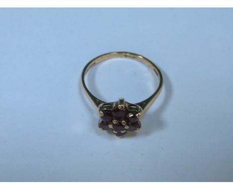 9ct GOLD FLORAL DRESS RING SET WITH RUBY COLOURED STONES