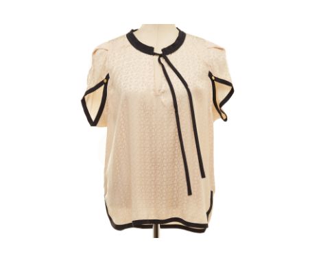 A LOUIS VUITTON CREAM MONOGRAM SILK BLOUSE
LV monogram silk blouse with navy detailing to the sleeves and neckline, with key 