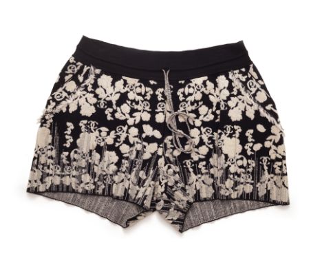 A PAIR OF CHANEL FLORAL KNITTED SHORTS
Black and white foliate design featuring the CC logo, elasticated with drawstring tie

