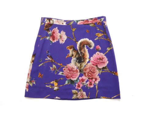 A DOLCE &amp; GABBANA 'ENCHANTED FOREST' SKIRT
Knee length, the print featuring a squirrel, birds and flowering branches
Dolc