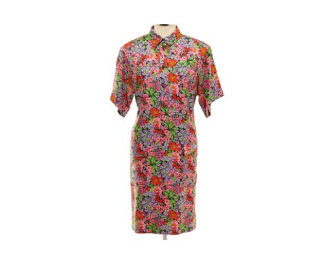 A DOLCE &amp; GABBANA FLORAL PRINTED SILK SHIRT DRESS
Multicoloured floral knee length button up dress with two pockets to th