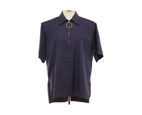 A CELINE NAVY SHORT SLEEVED SHIRT
Navy blue cotton zip-up shirt, with a larger gold tone ring zipper, with original swing tag