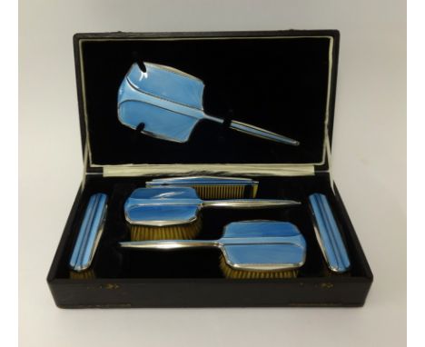 An art deco six pieced cased blue enamel and silver dressing table set, comprising mirror, two clothes brushes, two hairbrush