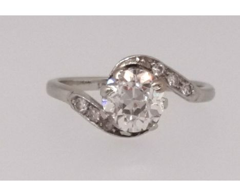 A single stone diamond ring of twist design set with an old cushion round cut diamond on diamond shoulders, approx 1ct. stamp