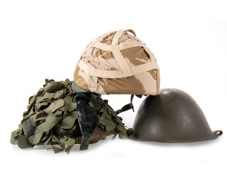 BRITISH MkIV HELMET with interior label dated 1976 and with broad arrow, with webbing and chinstrap, net and scrim cover, alo