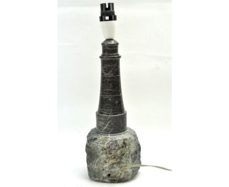 A vintage Cornish Serpentine table lamp in the form of a lighthouse, mounted on a naturalistic stone base, with a textured sh