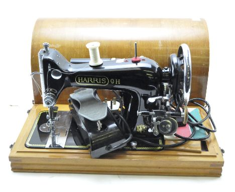 A Harris 9H sewing machine and a sewing table, the sewing machine contained in a wooden carry case, width 46cm, the table of 