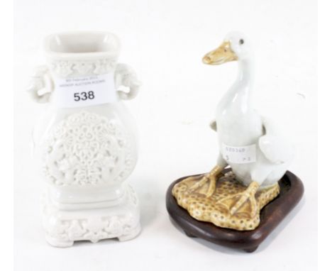 A 20th century glazed ceramic oriental gourde vase and a figure of a duck, of which being raised upon a wooden stand, largest