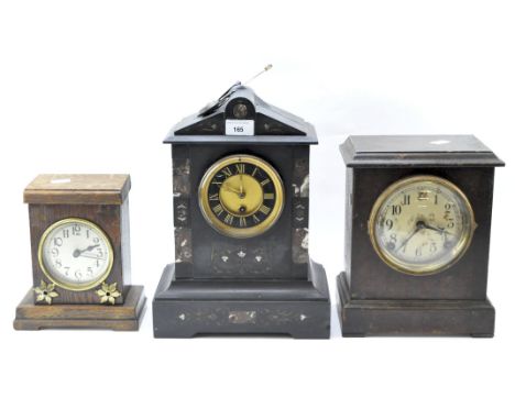 A group of three vintage mantle clocks, one being housed in a slate case, its dial with Roman numerals denoting hours, anothe