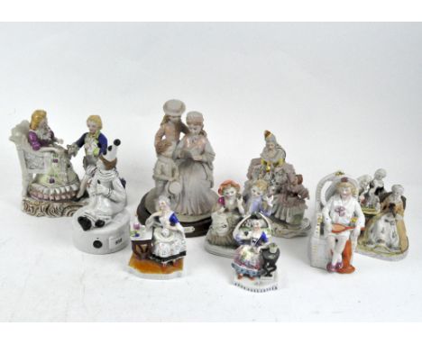 A collection of ceramic figures, late 19th/early 20th century, including a Dresden figure group, a clown, a model of a boy ho