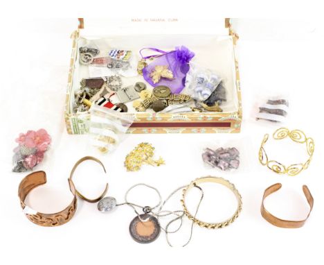 A collection of costume jewellery, including copper bangles, enamel badges, earrings, bracelets and more