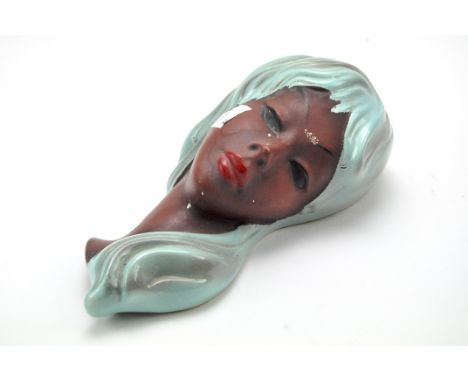 A Cortendorf 1950's ceramic wall designed by Albert Strunz, modelled as a female head in the side profile, the skin in brown 