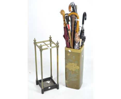 Two umbrella stands and assorted umbrellas, one stand with a metal frame and square base, height 61.5cm, the other a ceramic 