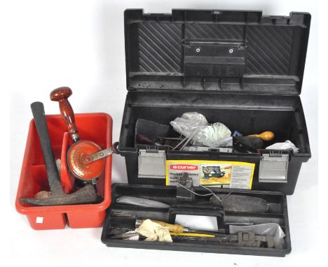 A black plastic Curver tool box, containing an assortment of tools and equipment