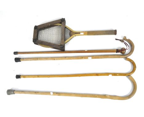 A collection of vintage walking sticks and tennis racquet, the wooden racquet by Handicap, one stick with turned wooden handl