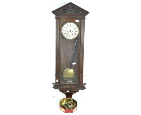 An early 20th century oak cased Vienna wall clock, with glazed front and side panels, the dial with Roman numerals denoting h