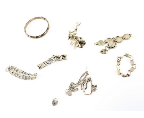 An assortment of silver jewellery, including a bangle, fob chain, padlock bracelets, a coin bracelet and more, combined weigh