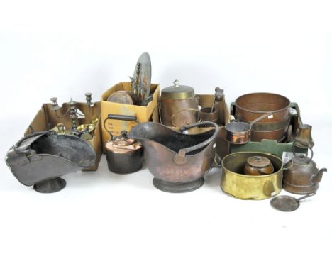 A large quantity of brass and metalware, including two sets of scales, a kettles, coal scuttle, assorted pans, a candlestick 