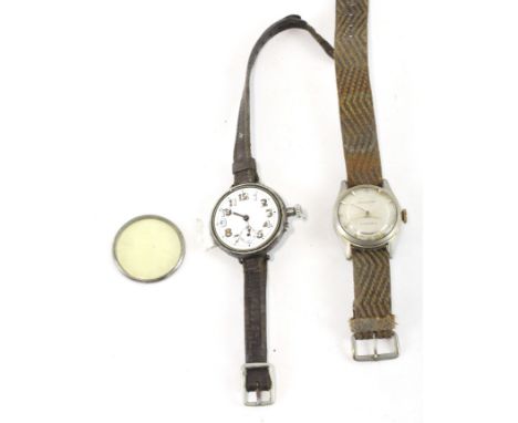 Two vintage wristwatches, one being an early 20th century trench watch, housed in a white metal case, the enamel dial with Ar