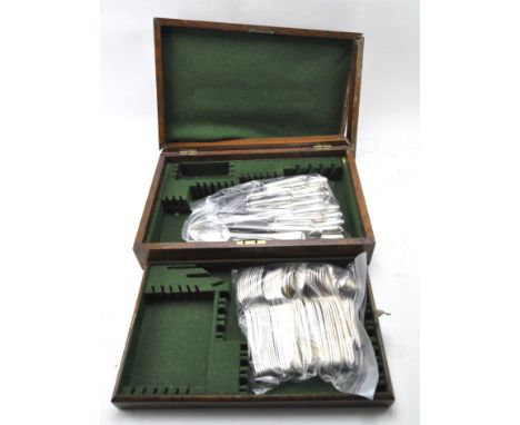 An early/mid century Oak canteen containing later silver plated flatware, including forks, spoons and knives, the canteen mea