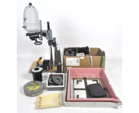 A Gnome Beta 35 photographic enlarger on adjustable stand with baseboard, 50mm lens and 35mm negative carrier, together with 