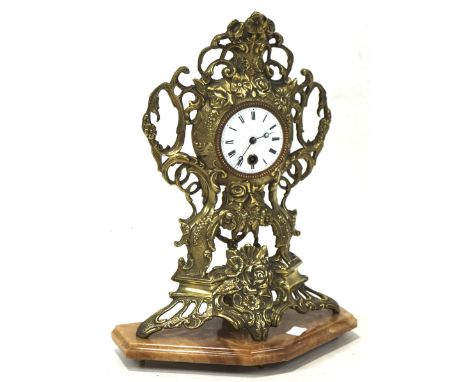 A Victorian Rococo style mantle clock, the gilt cast metal frame decorated with flowers and scrolling motifs, white enamel di