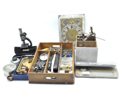 A collection of assorted clock and watch related accessories, including dials, movements, albert chains, tools and much more