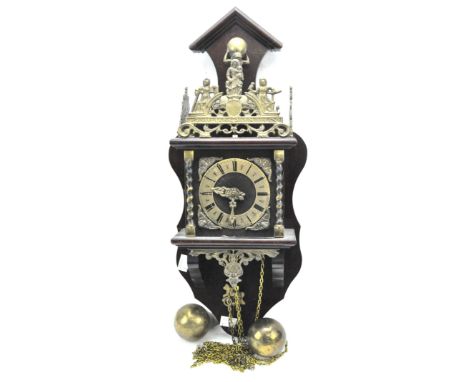 A mid century reproduction wall clock, the gilt metal chapter ring dial with Roman numerals denoting hours, in stained wooden