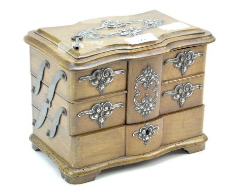 A Continental mahogany commode shaped trinket box, late 19th century, of serpentine outline with silver coloured foliate moun