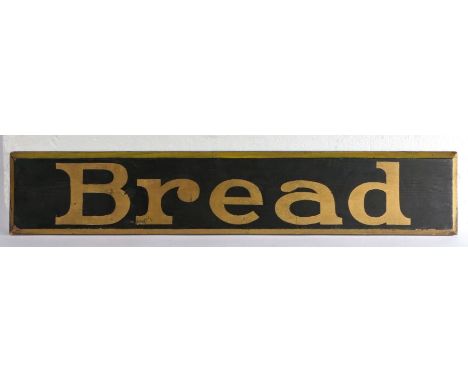 Ebonised advertising panel with gilt lettering "Bread", with bevelled gilt painted border, 90cm wide, 16.5cm high