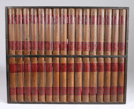 Early 20th Century faux book panel, circa 1920, modelled as thirty-two book spines arranged in alphabetical order, 88cm wide,