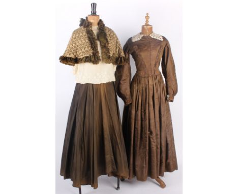 Six pieces of late 19th century costume; comprising: a green silk cape, a sage green skirt with brocade trim, a cream lace bl