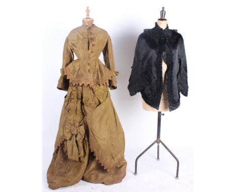 Five items of 19th century ladies costume, comprising: a black bolero trimmed with ribbon and lace, an olive green two-piece 