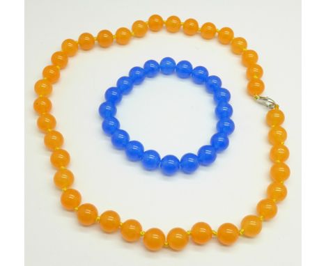 An orange jade necklace and a blue jade bracelet 