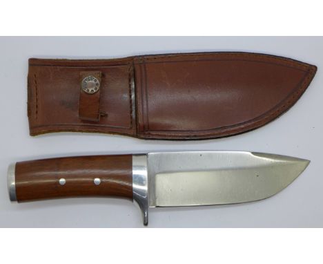 A hunting knife with leather scabbard 