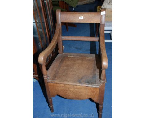 An oak commode chair.