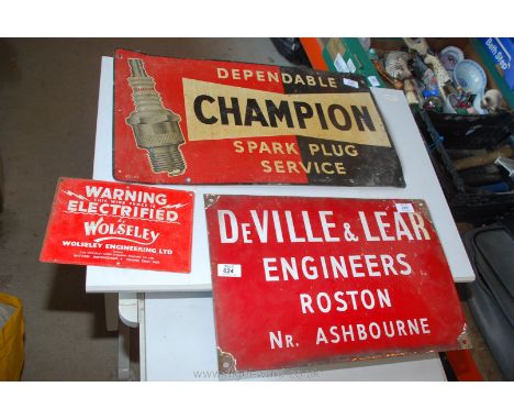 An enamel sign and two painted signs.
