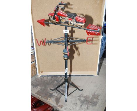 A modern style weather vane in the form of a motorcycle.