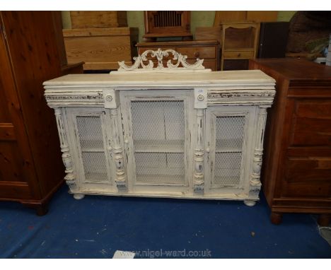 A painted buffet base with netting wire doors in Shabby Chic style, 53" long x 15" deep x 35" high.