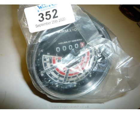 A new/unused tractor rev-counter/hour-meter/speedometer, cable driven, 0 - 2,400 R.P.M. with bands for travel speeds for 3 lo