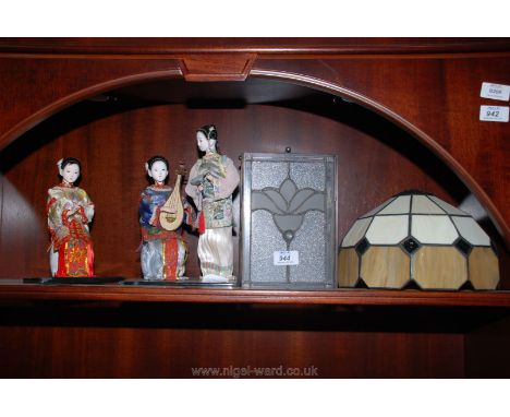 Two glass lamp shades and two Oriental figures.