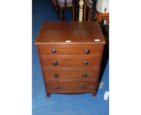 A commode in the form of a faux four drawer cupboard.