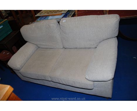 A two seat sofa with removable arm covers and cushions.