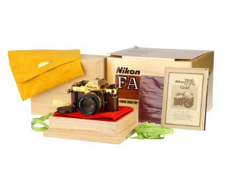 A Nikon FA Gold 'Grand Prix '84' SLR Camera, 1984, gold, serial no. 2003158, with Nikon Ais Nikkor f/1.4 50mm lens, black/gol