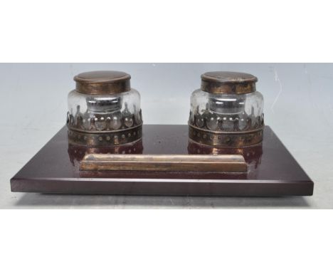 A 20th century vintage retro desk inkwell stand. The stand having two glass inkwell with hinged metal tops, circular pierced 