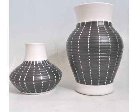 A pair of vintage retro 20th ceramic two tone Denby stone ware jugs / water jugs. The jugs having flat handles with black rai