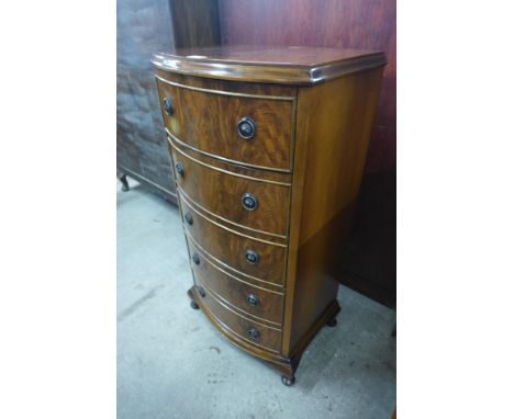 A small walnut bow front chest of drawers 